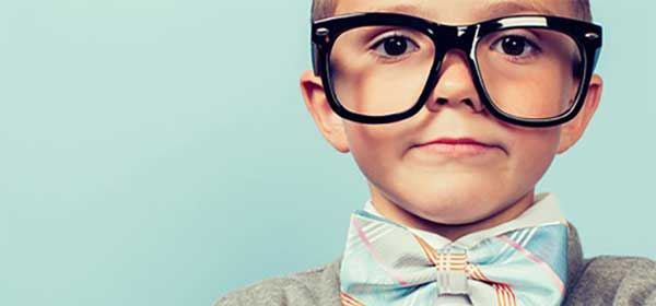 Smart child wearing glasses and bow tie.